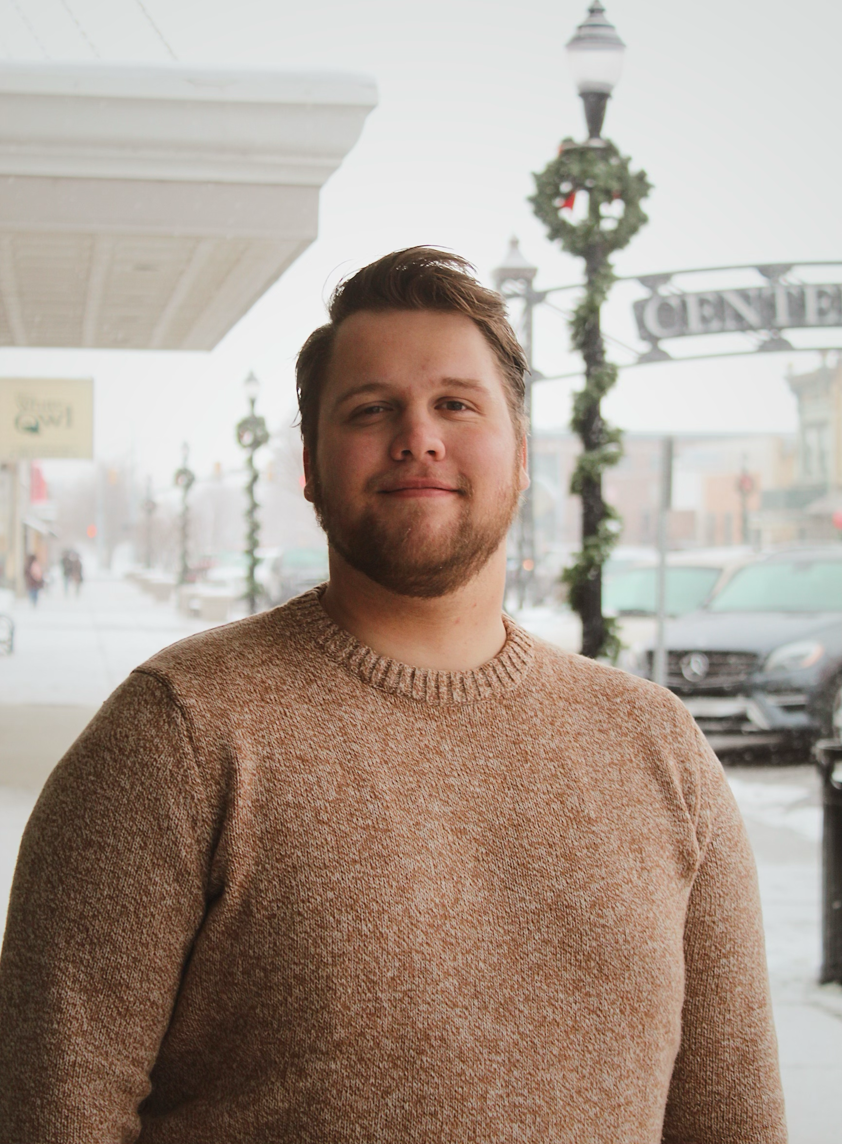 Photograph of Sam holding a tuba.